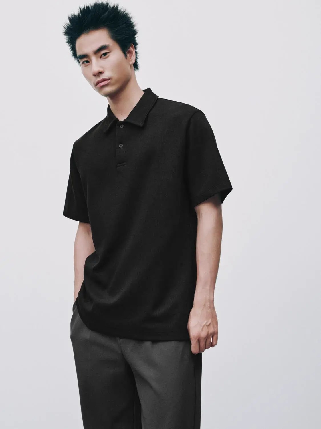 Textured brushed polo shirt in black, cotton blend for men.