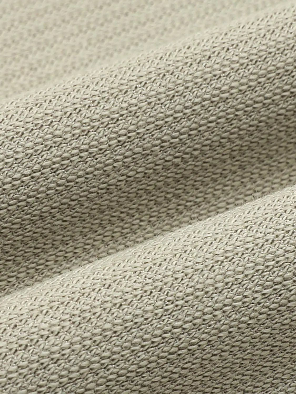 Textured brushed polo cotton-blend shirt fabric close-up in beige
