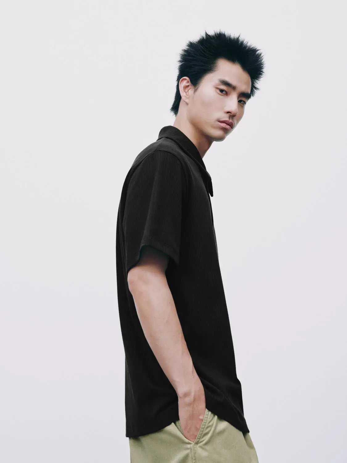 Polo shirt, black, short sleeves, worn by male model