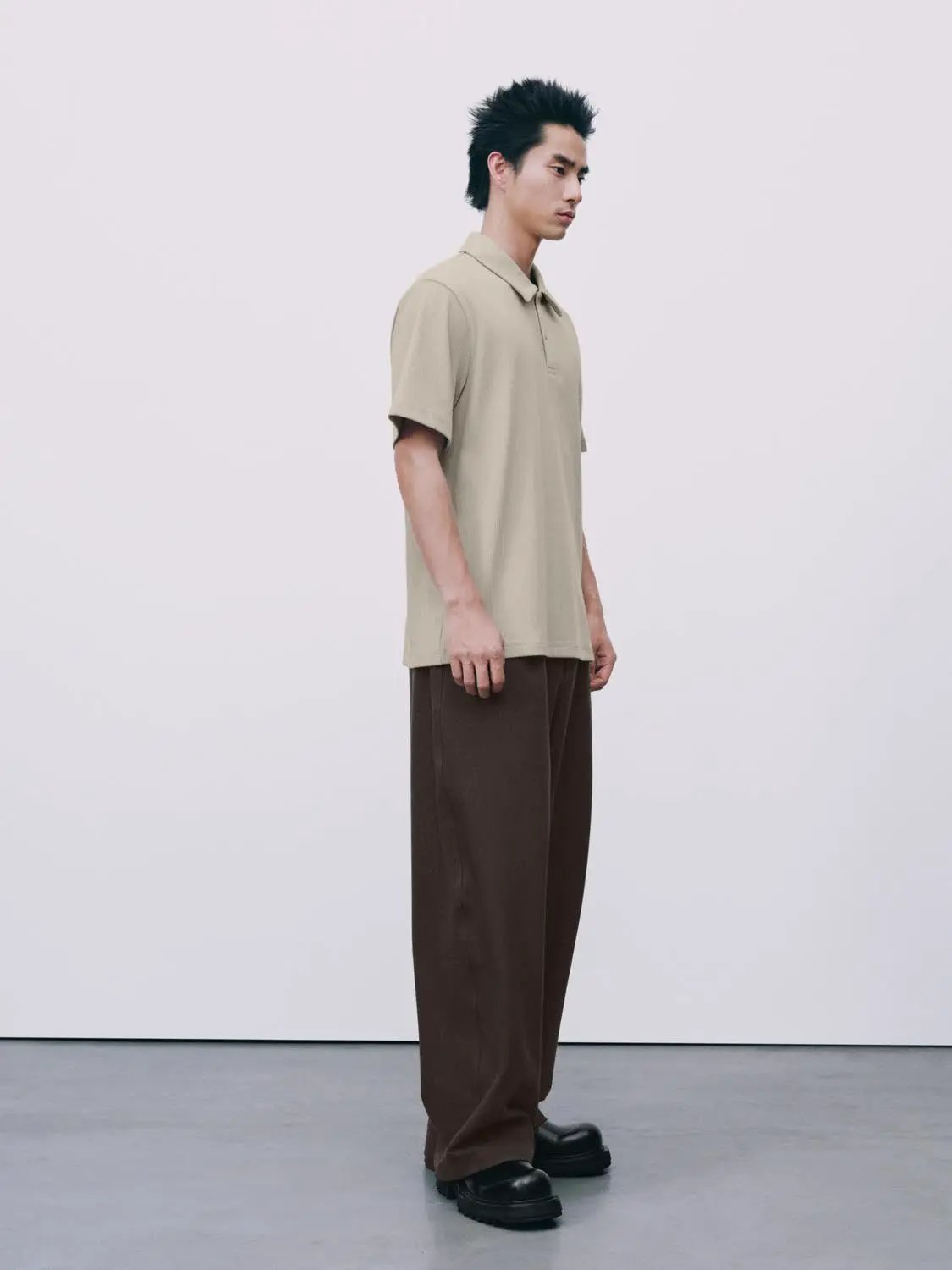 Polo shirt in beige paired with brown trousers