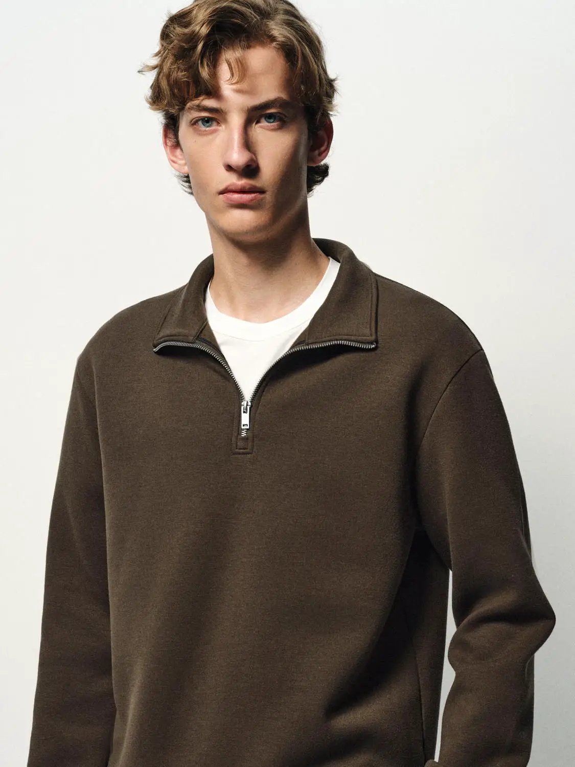 Sweatshirt, brown zip-neck pullover with a white T-shirt underneath