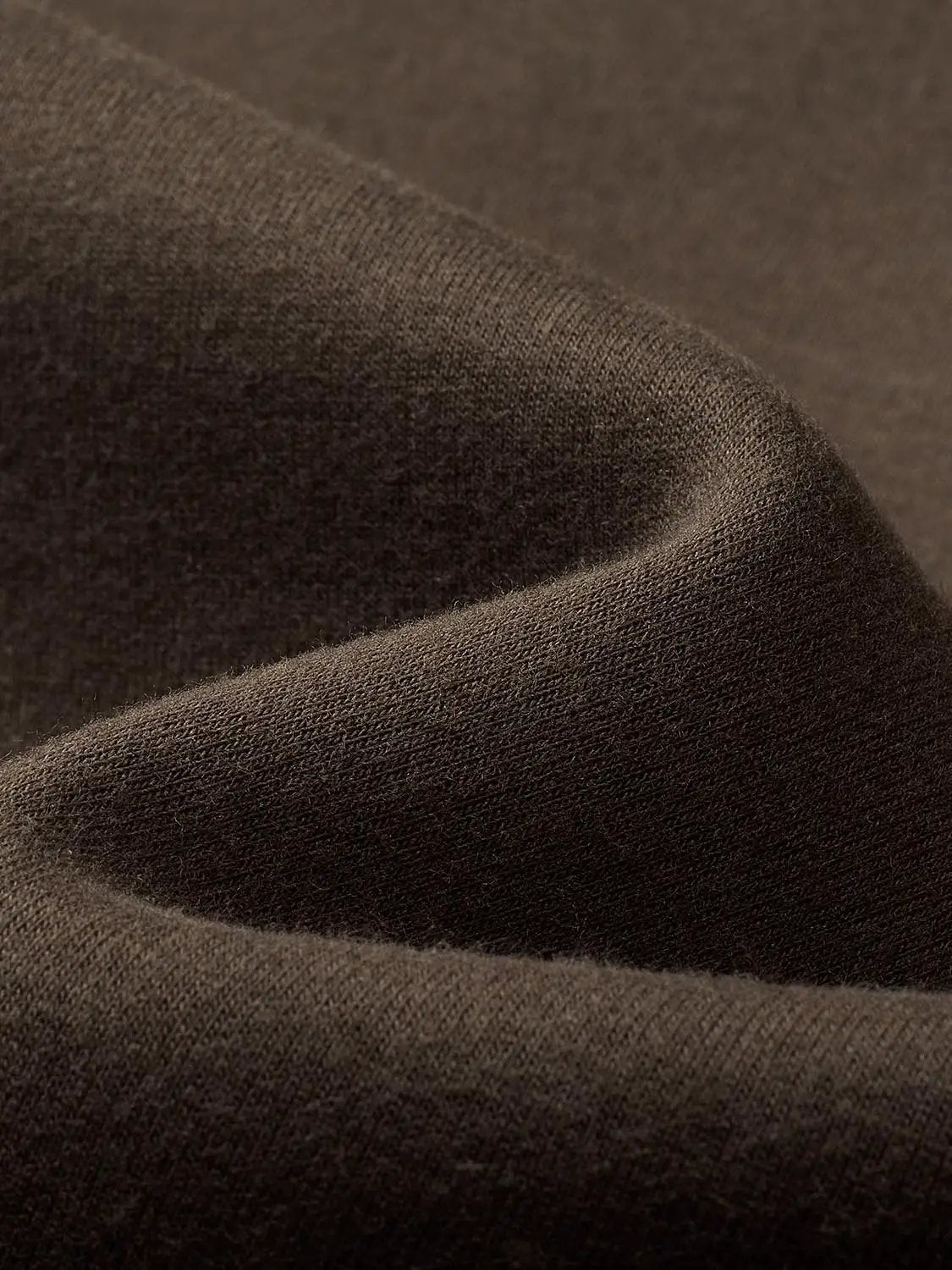 Sweatshirt fabric close-up in dark brown knit textile