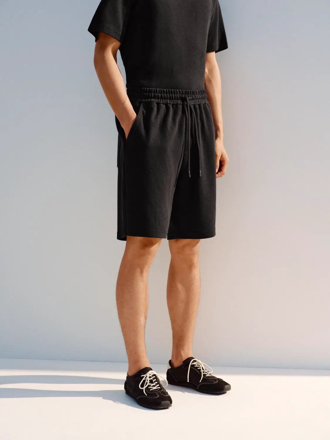 Elastic drawstring waist cotton blend shorts for men, black.