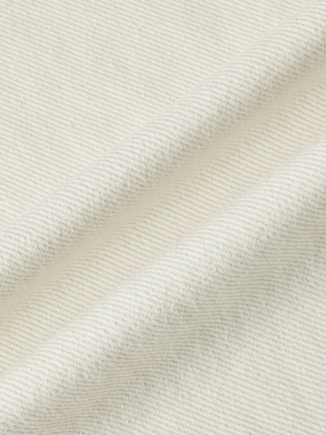 Casual Jeans fabric close-up in cream with diagonal twill texture