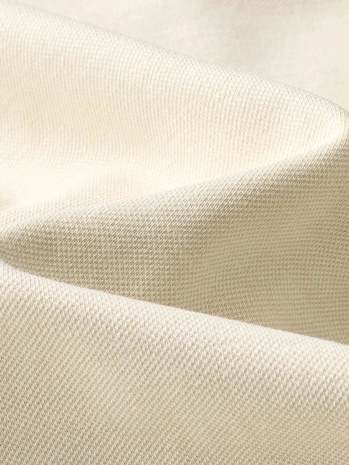 Polo shirt fabric close-up in beige with textured weave