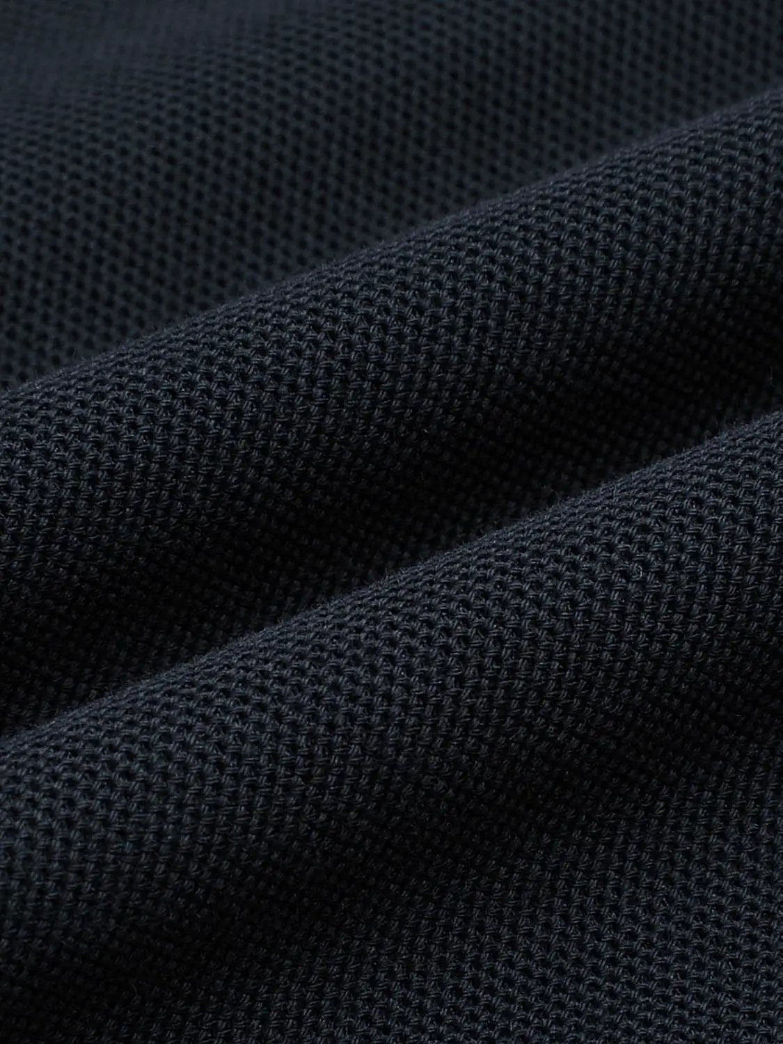Polo shirt navy pique-knit fabric close-up