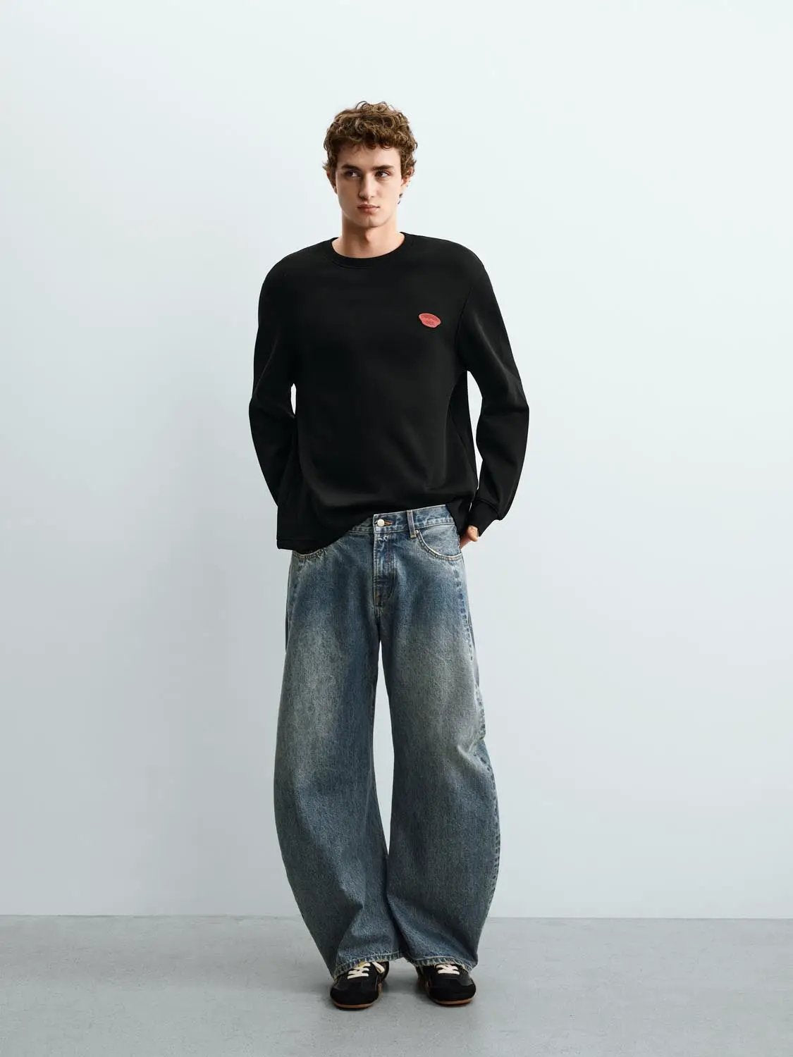 Sweatshirt by Urban Revivo Fashion, black with red emblem, oversized fit