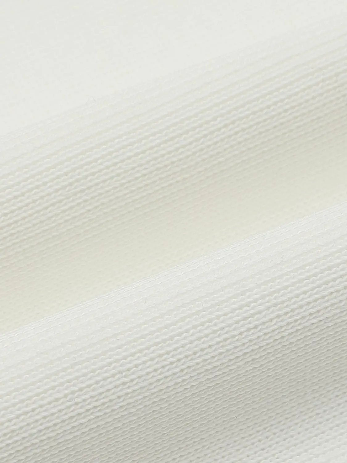 Sweatshirt fabric close-up in cream knit with ribbed texture