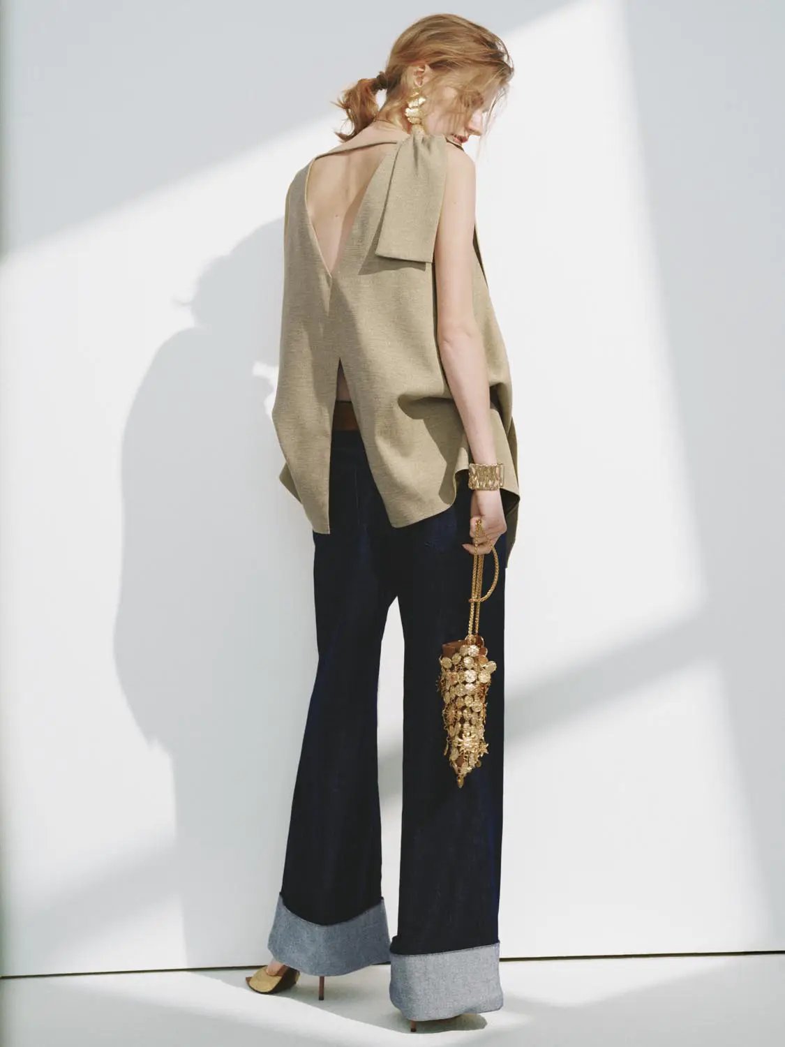 Textured draped overlay beige sleeveless overhead shirt with back V opening.