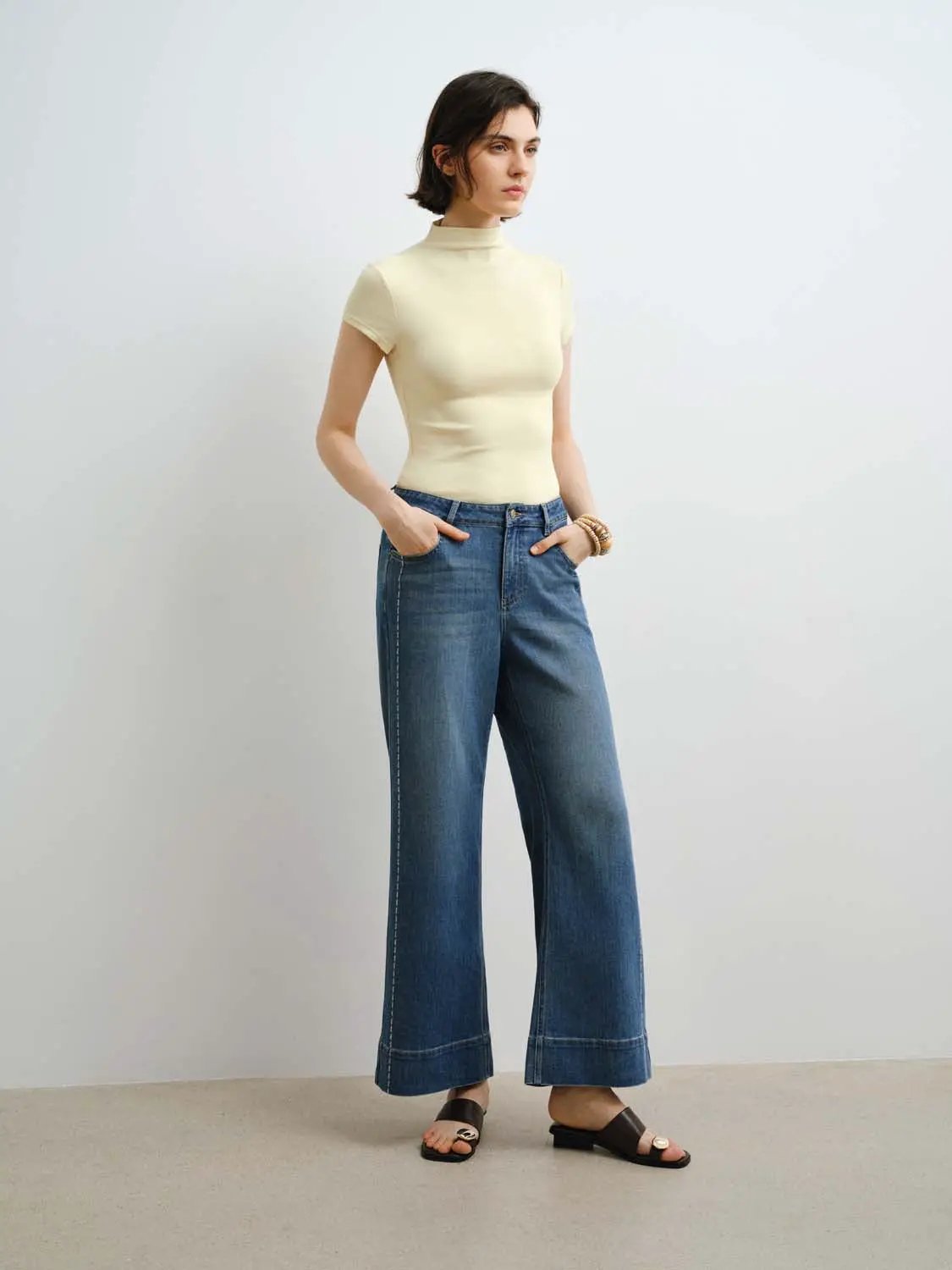Modal knit T-shirt in cream with a smooth finish; two-piece outfit with wide-leg denim jeans.