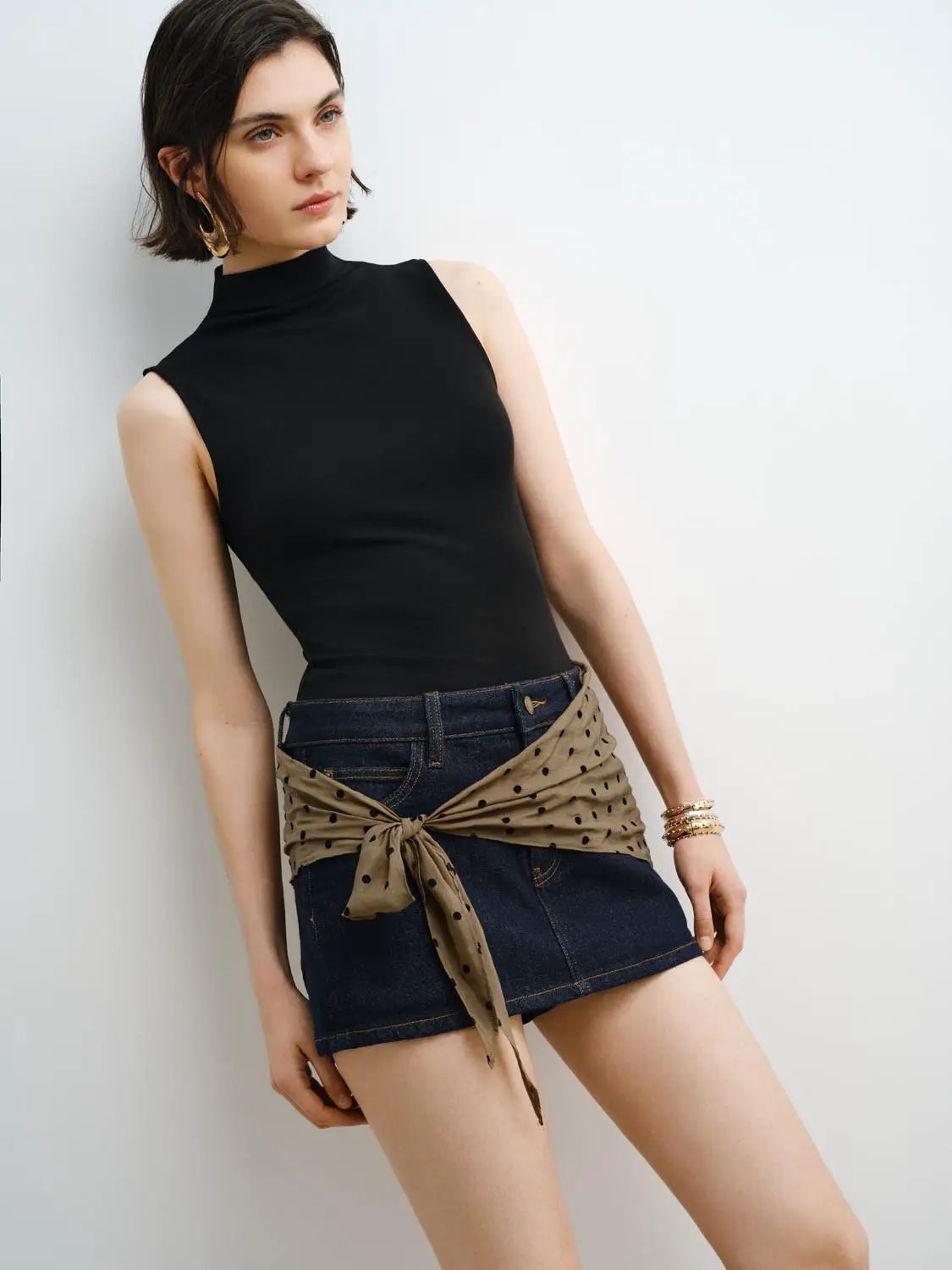 Tank Top by Urban Revivo Fashion, black sleeveless high-neck; paired with a denim mini skirt and polka-dot scarf belt.