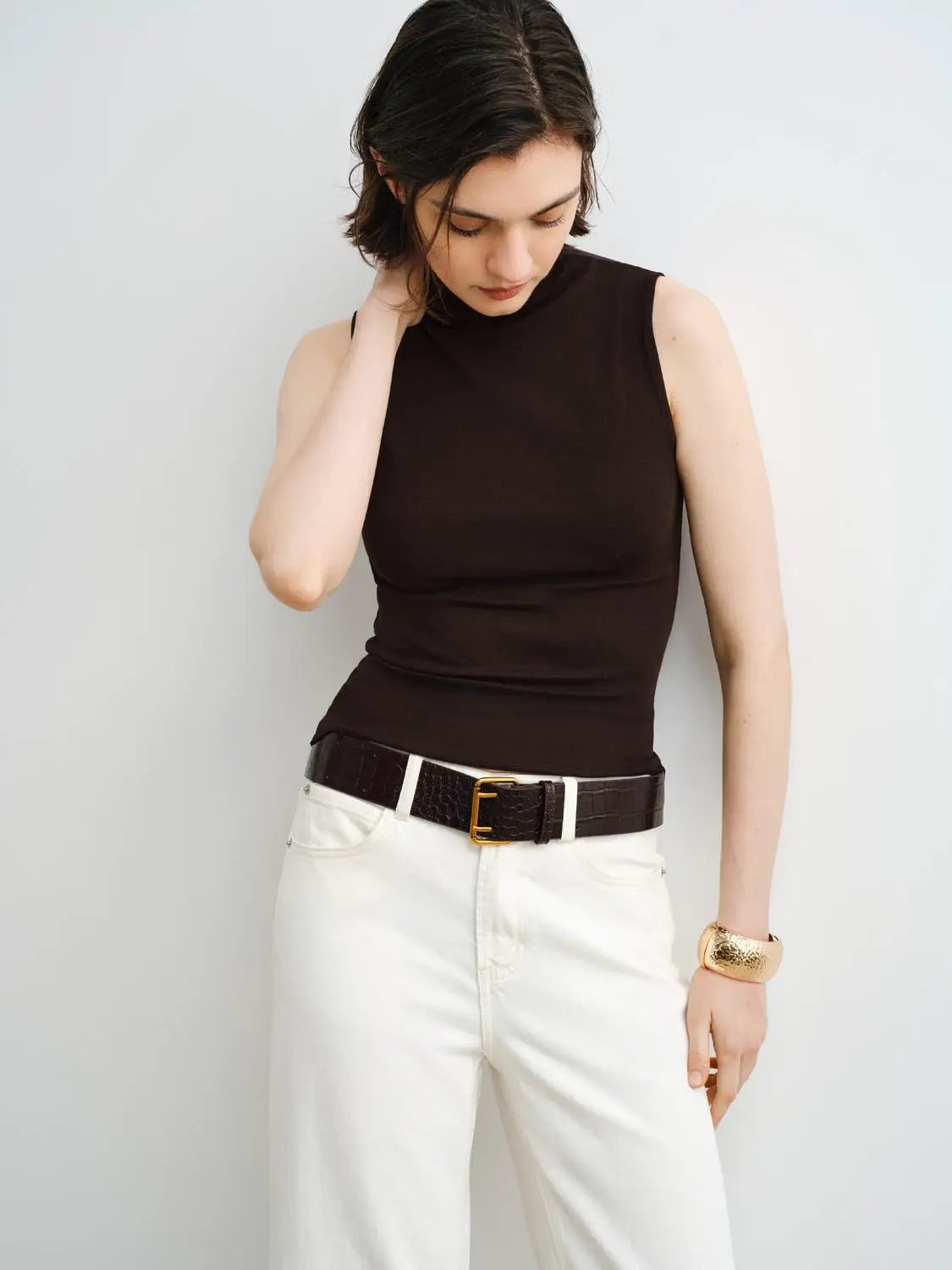 Tank top by Urban Revivo Fashion, black sleeveless high-neck, paired with white pants and a dark belt.