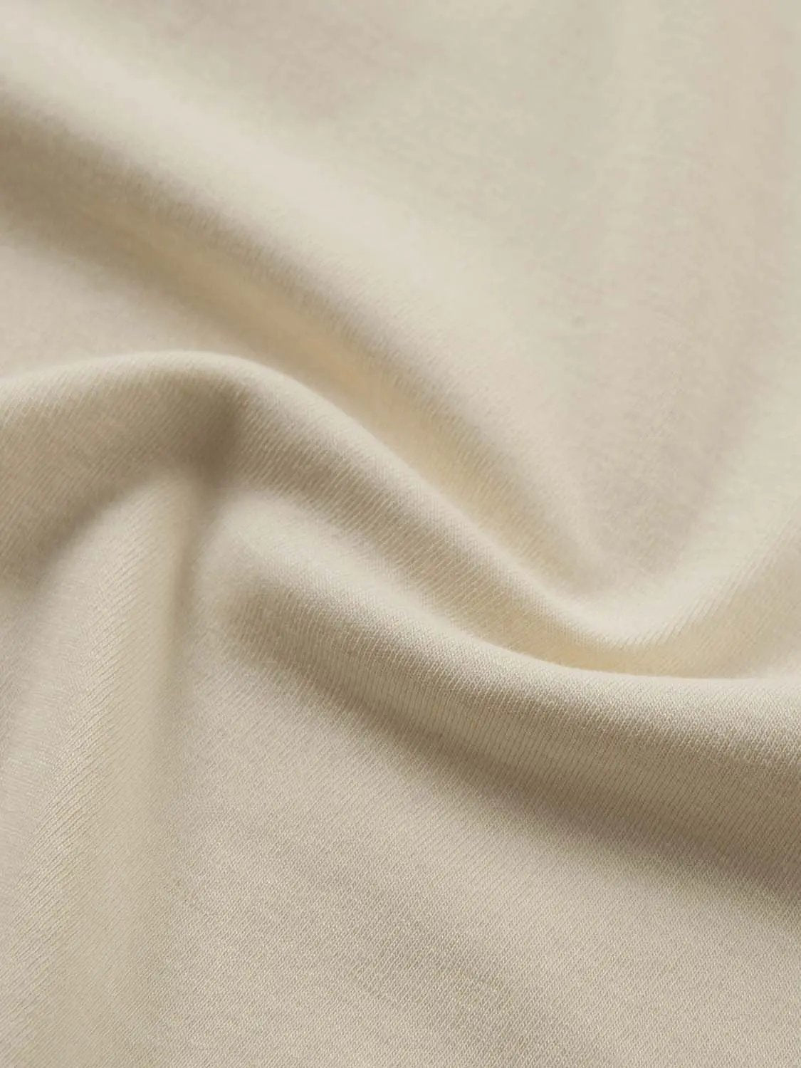 Tank Top fabric close-up in beige cotton with smooth texture and soft drape, neutral tone for versatile styling