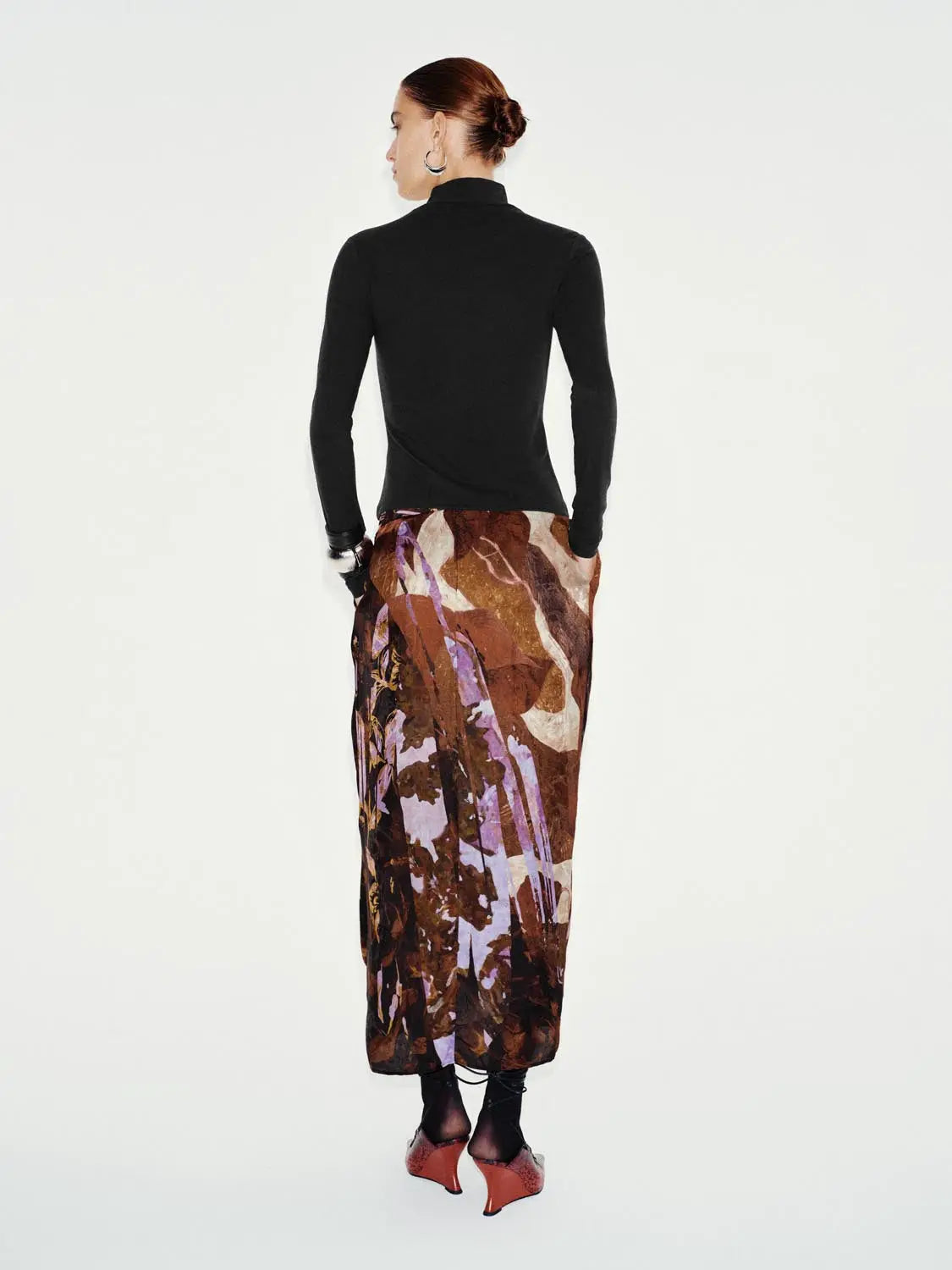 T-Shirt with black long-sleeve top paired with a brown and purple abstract-print maxi skirt