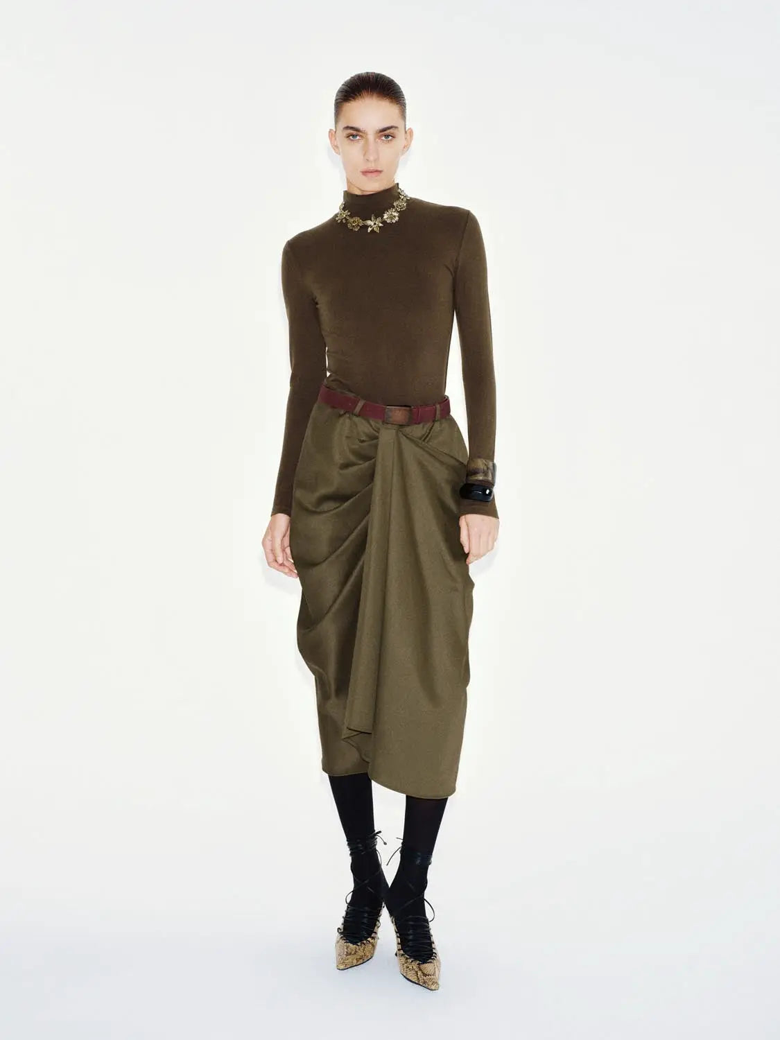 T-Shirt olive-green knit top with long sleeves and turtleneck, paired with draped olive skirt