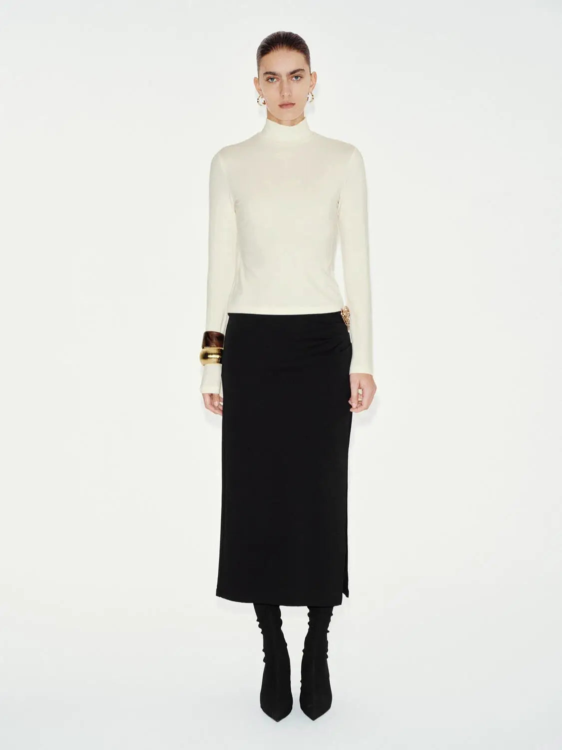T-shirt in ivory long-sleeve worn by model with black skirt