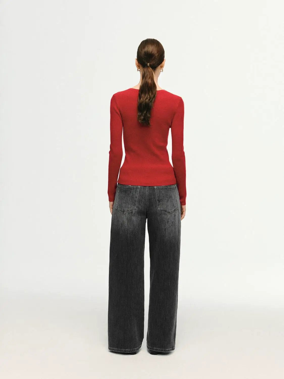 Slim ribbed knit long-sleeve T-shirt in red; back view of a model wearing dark wide-leg jeans.