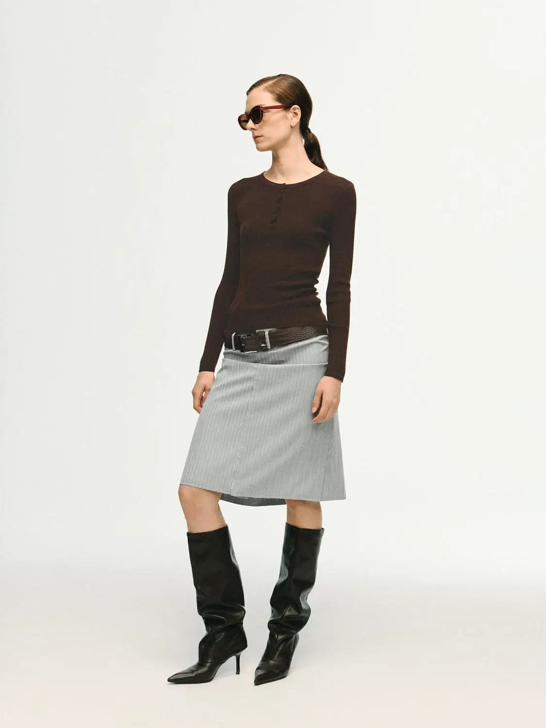 Slim ribbed button-front long sleeve T-shirt in brown, shown on a model with a gray skirt.