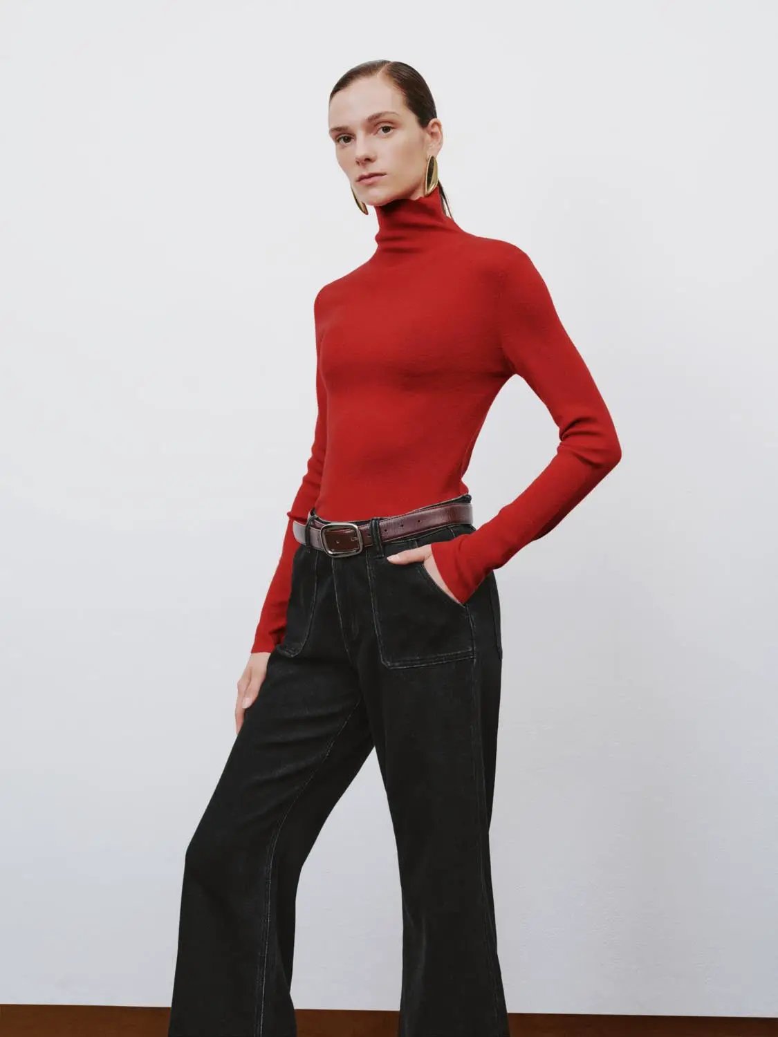 Ribbed fitted mock-neck long-sleeve red sweater; Urban Revivo Fashion with black denim jeans and a brown belt.