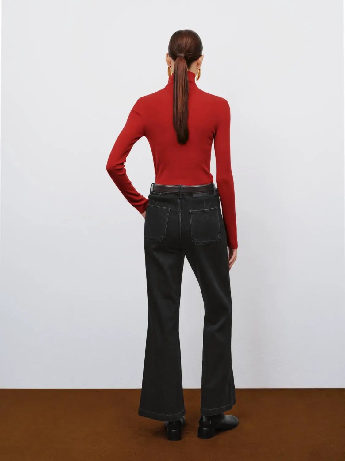 Ribbed Fitted Mock-Neck Long-Sleeve Sweater in red, shown from back with black wide-leg jeans.