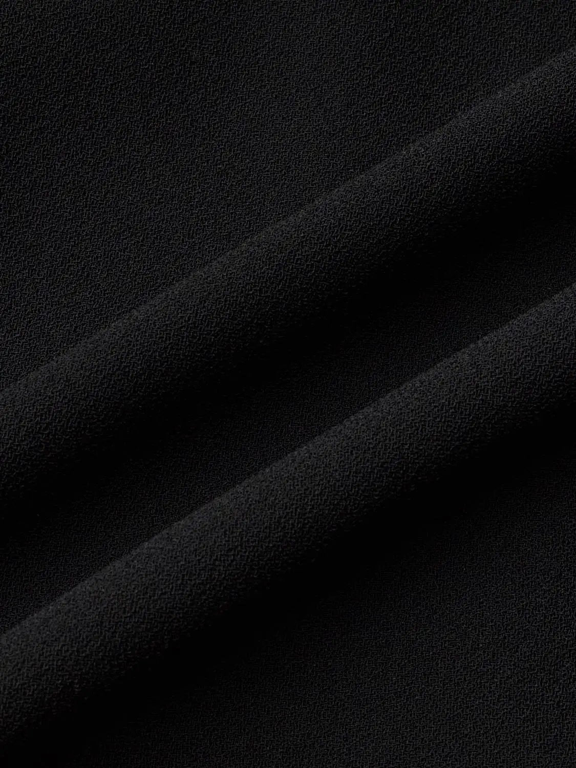 Sleeveless single-button vest fabric close-up in black by Urban Revivo Fashion