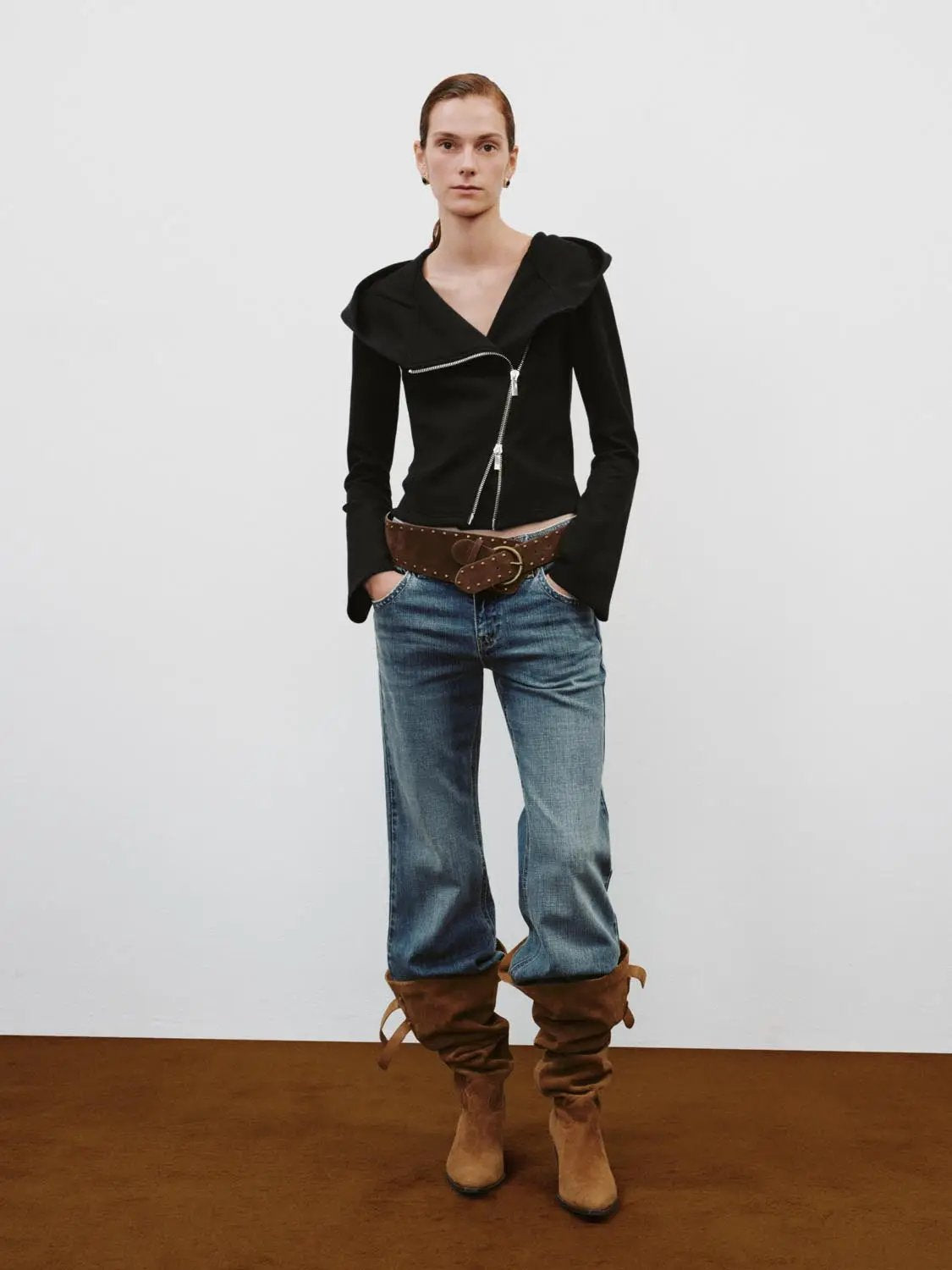 Asymmetrical Zip Hooded Cotton-Blend Hoodie, black; model in blue jeans and brown suede boots.