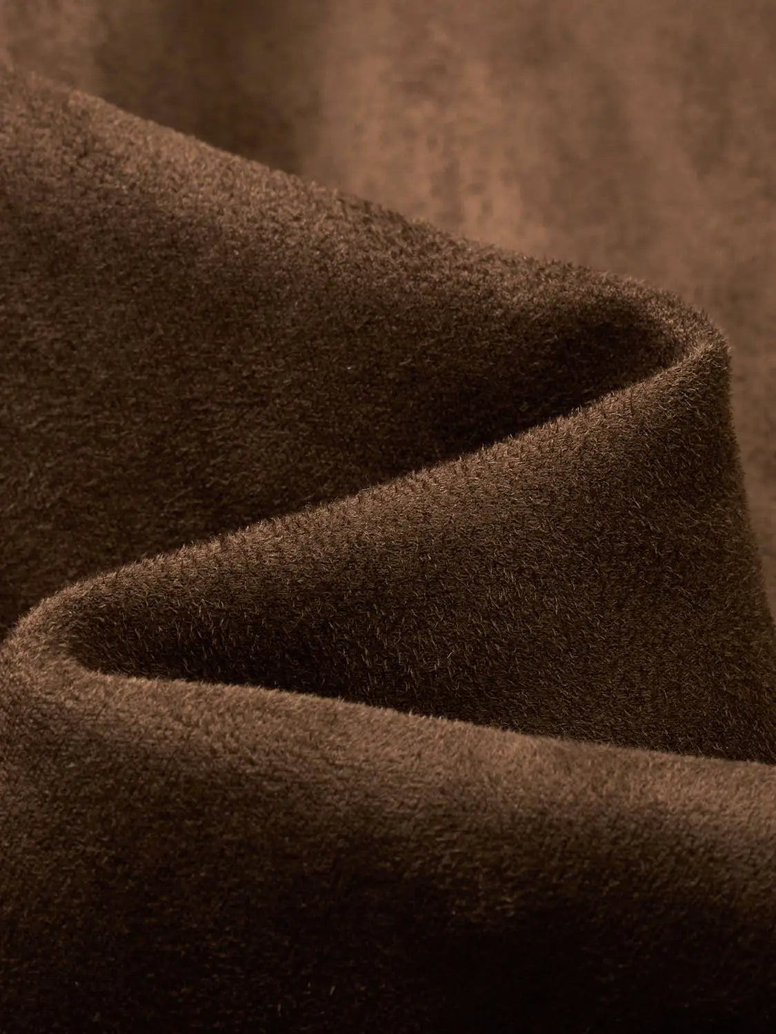 Coat close-up of dark brown wool-like fabric texture.