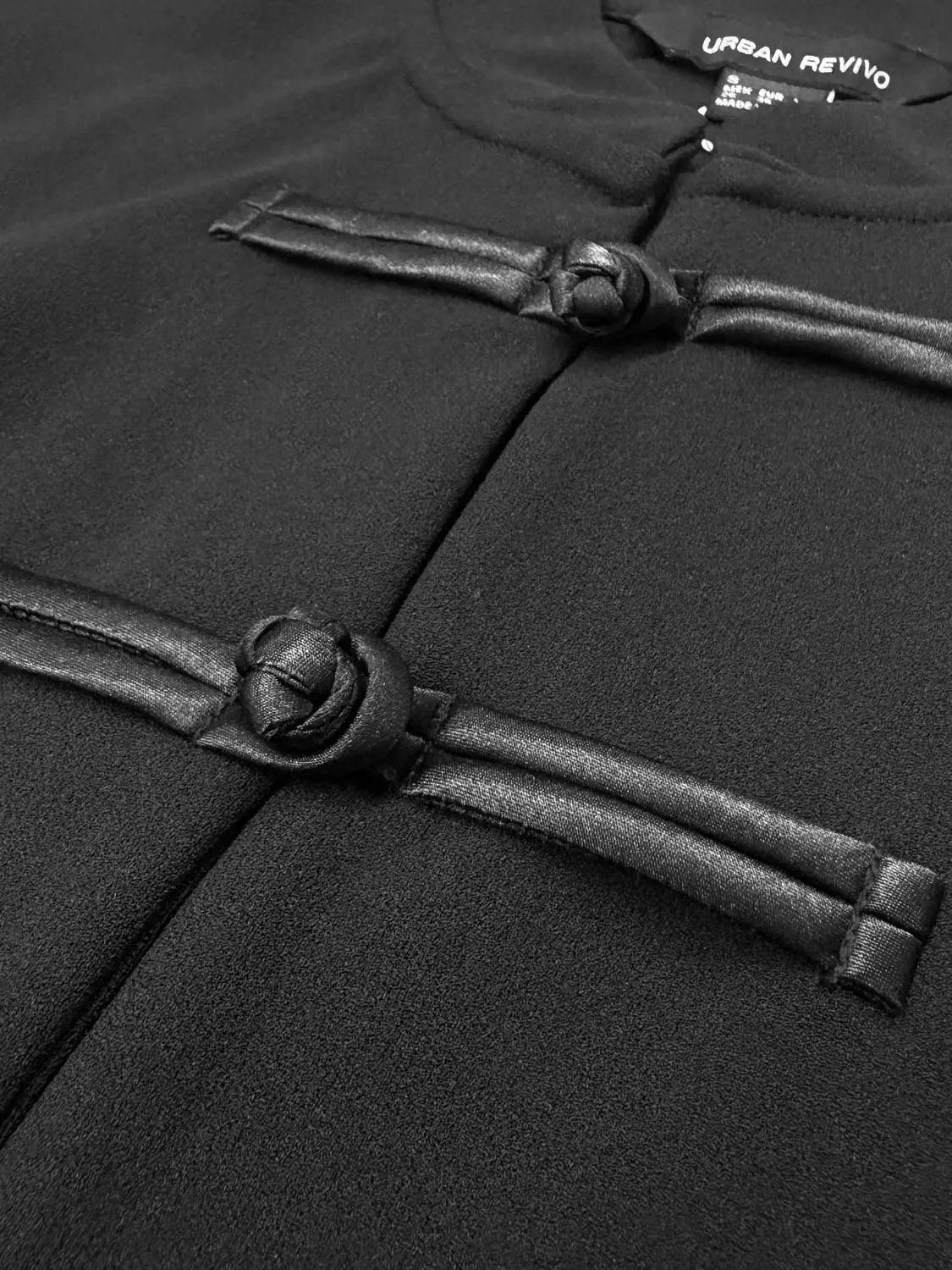 Frog-button Mandarin-collar sleeveless cardigan in black by Urban Revivo with two knotted frog closures