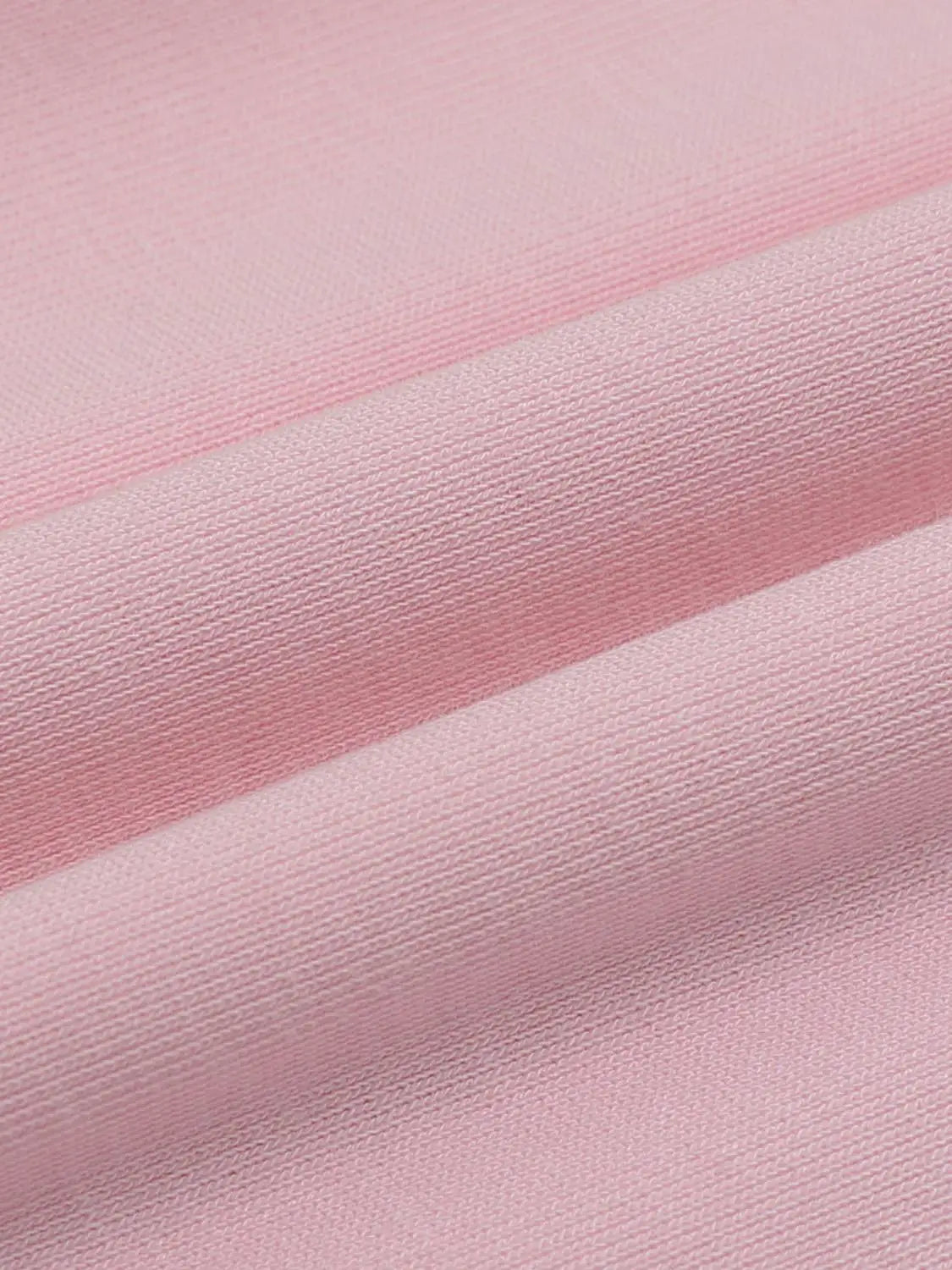 T-shirt fabric in soft pink knit, close-up showing fine rib texture