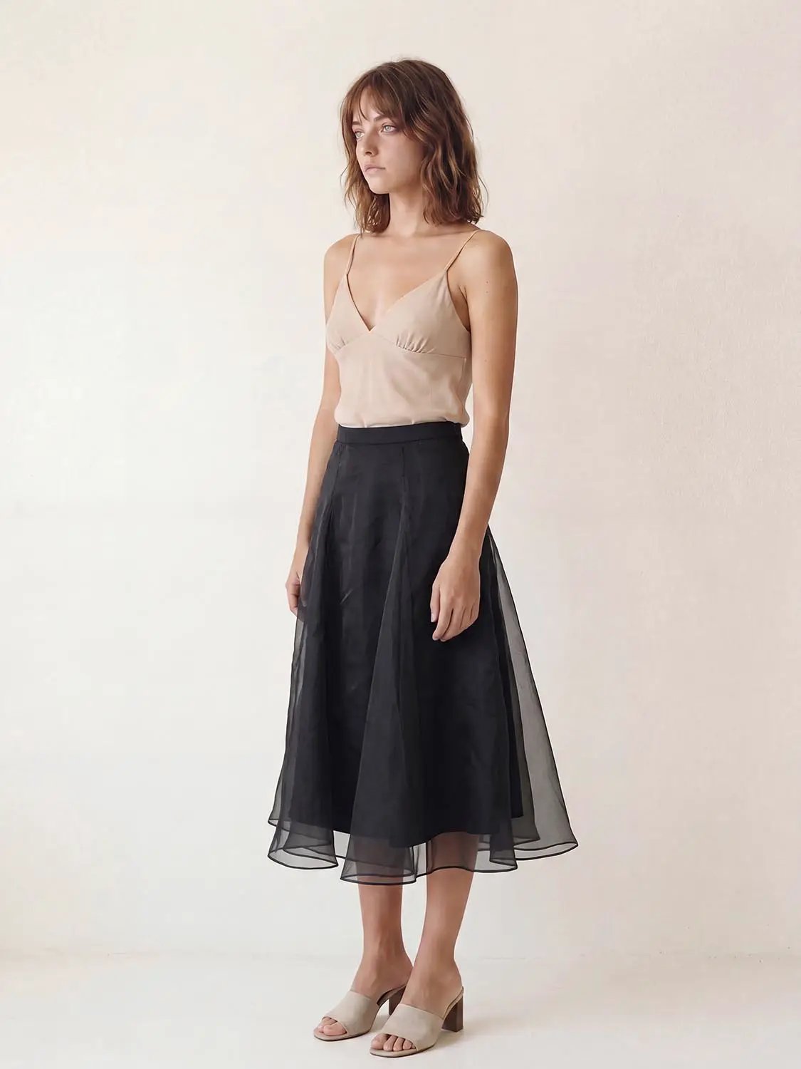 High waist irregular-hem mesh midi skirt in black with sheer overlay; Urban Revivo Fashion.