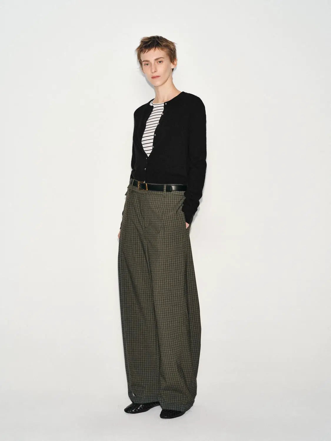 Wide-leg pants by Urban Revivo Fashion in olive-green plaid, worn with a black cardigan and striped top.