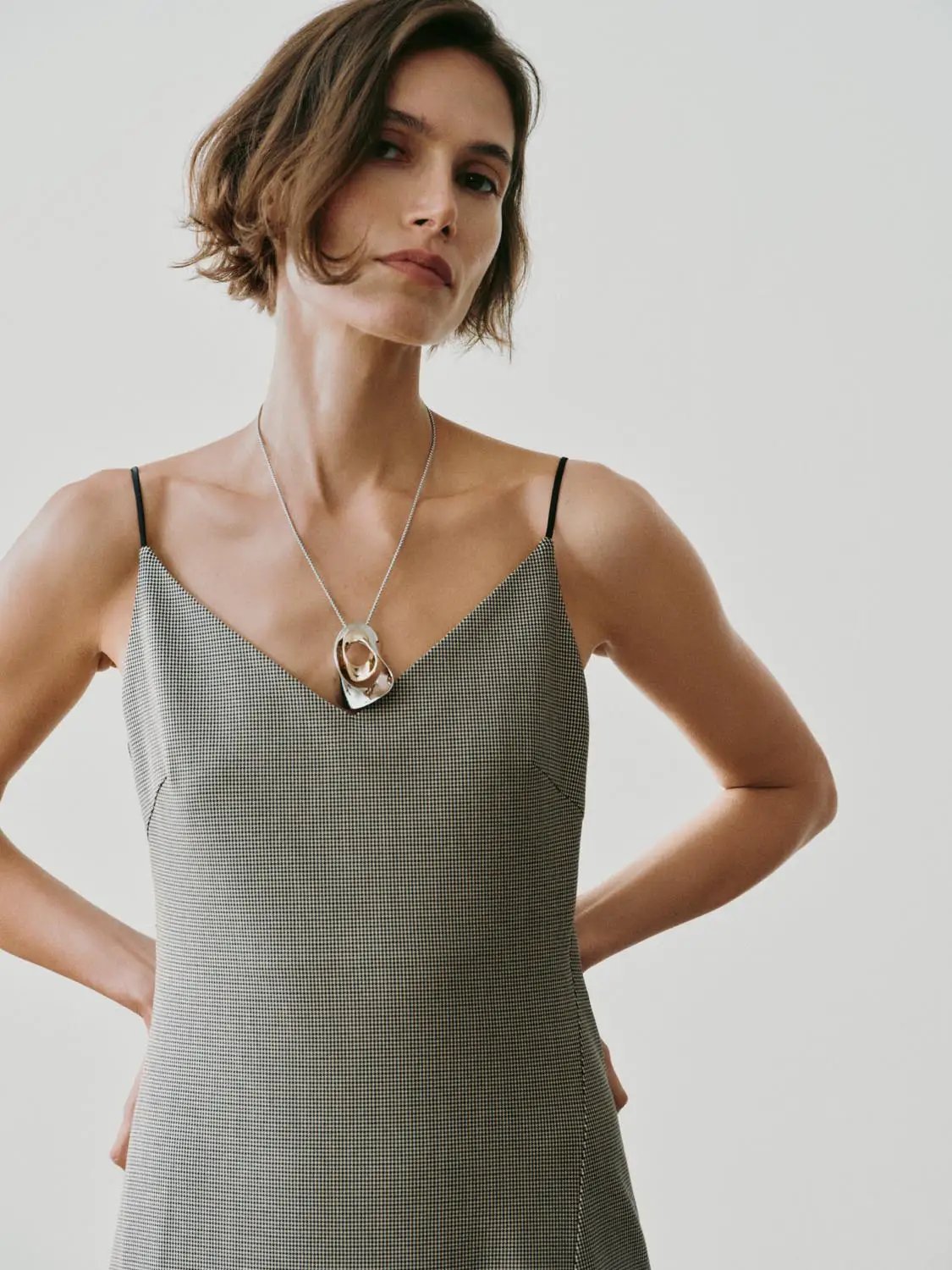 Slip maxi dress in gray gingham with a V-neck and thin black straps