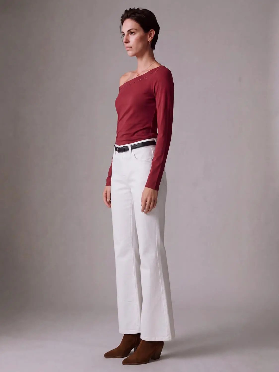 Mid Rise Belt Loop Cotton Stretch Flared Jeans in white, on model with brown ankle boots