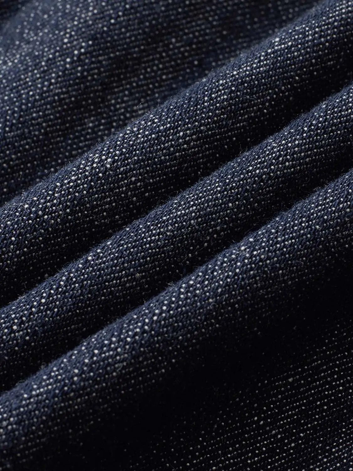 Denim Skirt fabric close-up in dark indigo denim with speckled texture, Urban Revivo Fashion.