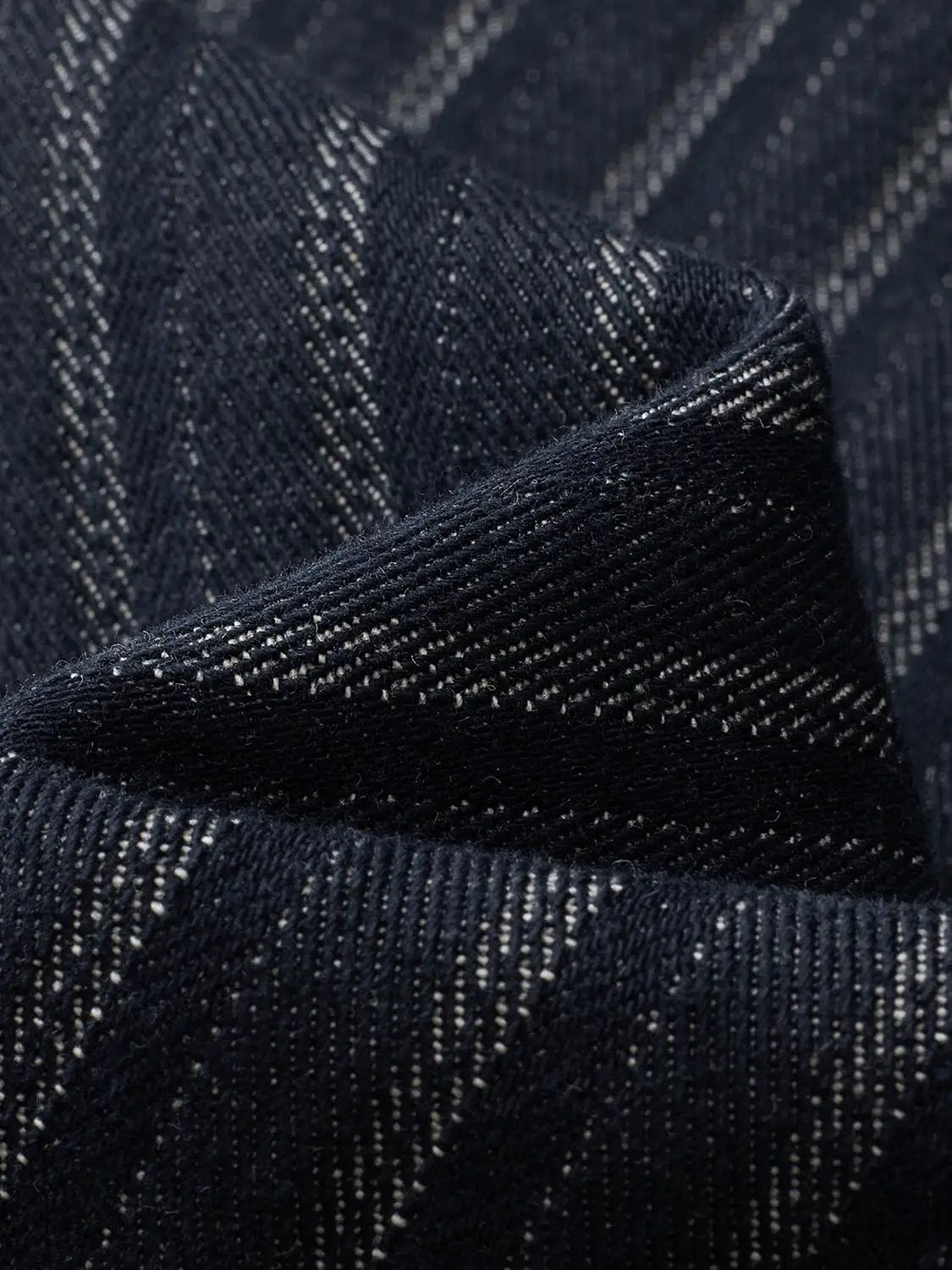 Jeans by Urban Revivo Fashion; dark blue denim close-up with textured weave.