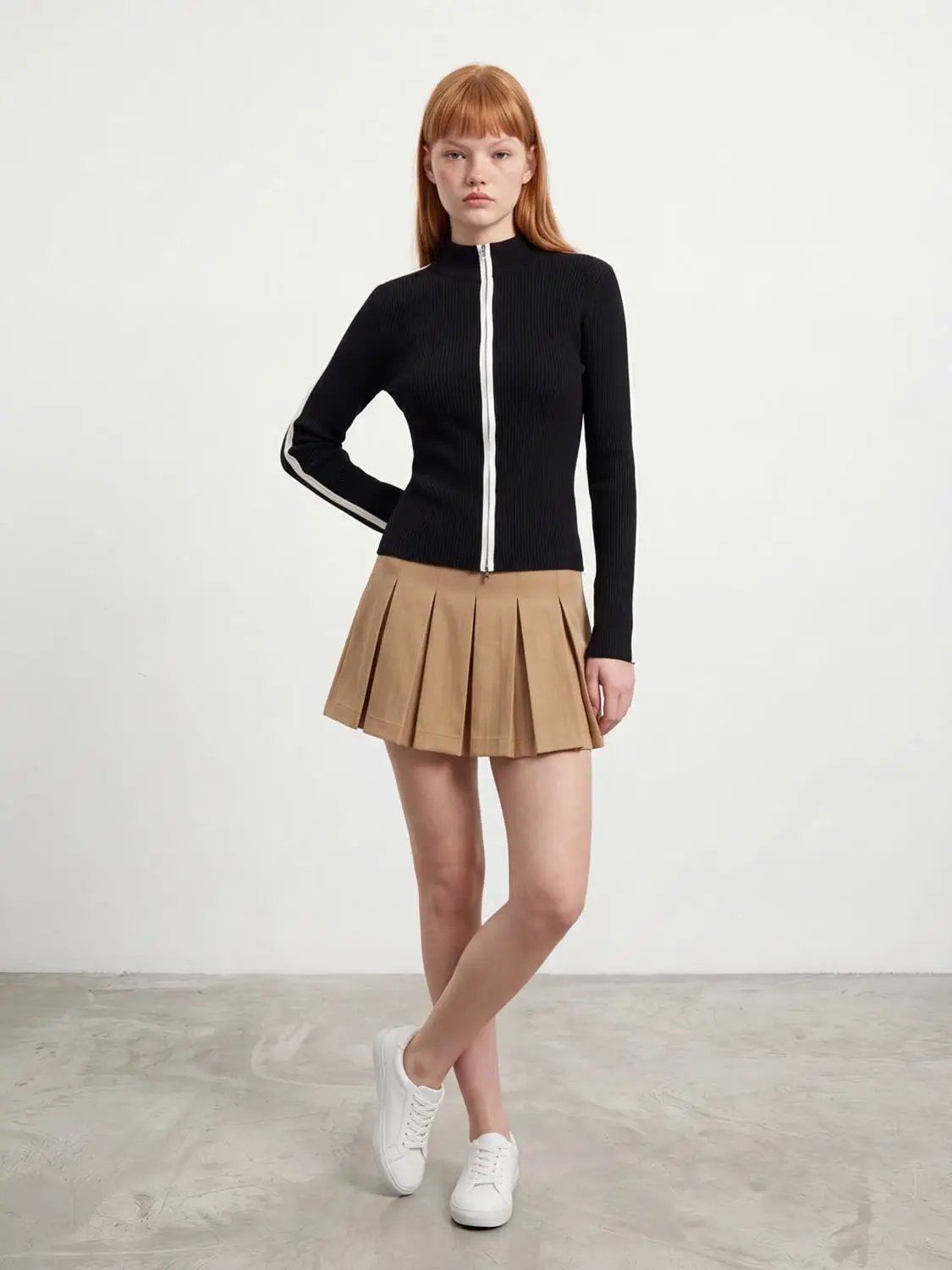 Contrast full-zip knitted cardigan in black with white zipper and white sleeve stripe.