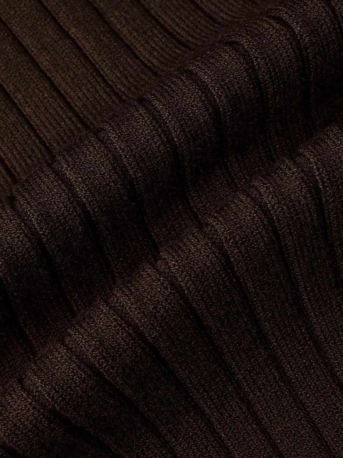 Ribbed knit cardigan fabric in dark brown with textured yarn close-up