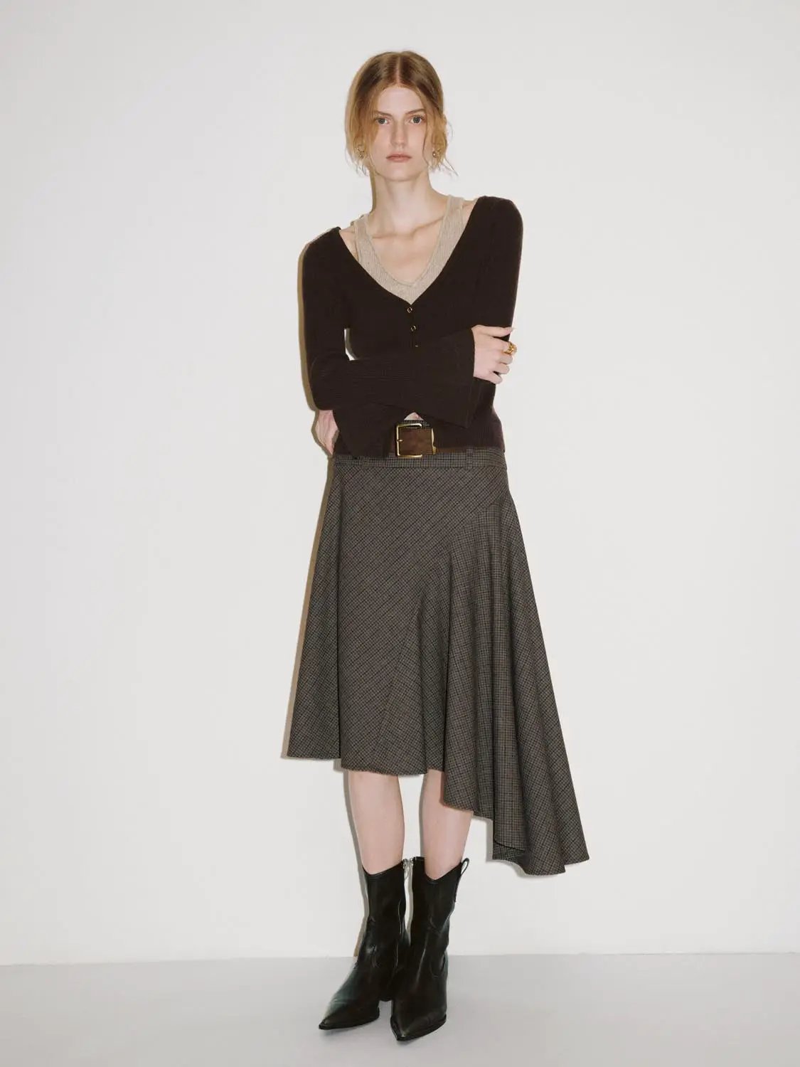 Urban Revivo Knit T-Shirt in dark brown with V-neck and button placket, worn with a grey check midi skirt and black boots