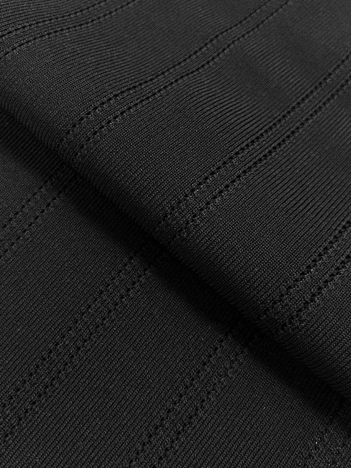 Urban Revivo knitted T-Shirts fabric in black, close-up of textured knit and stitching.