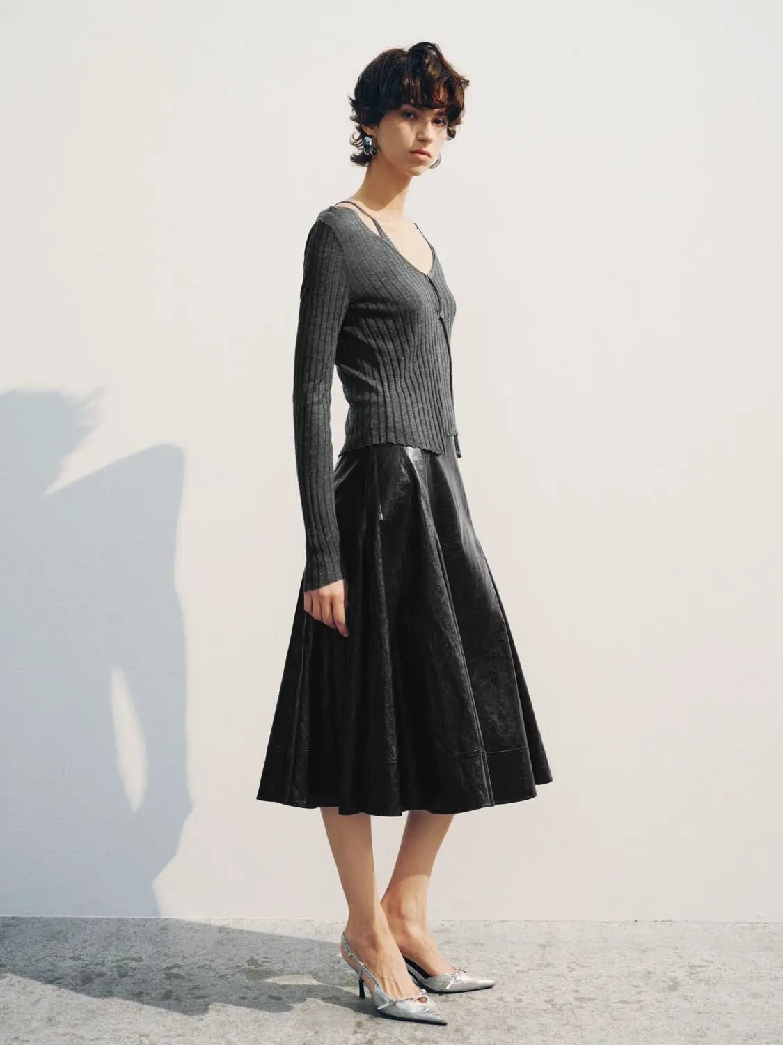 Fitted ribbed grey knitted V-neck button-front long-sleeve cardigan with black midi skirt, two-piece outfit