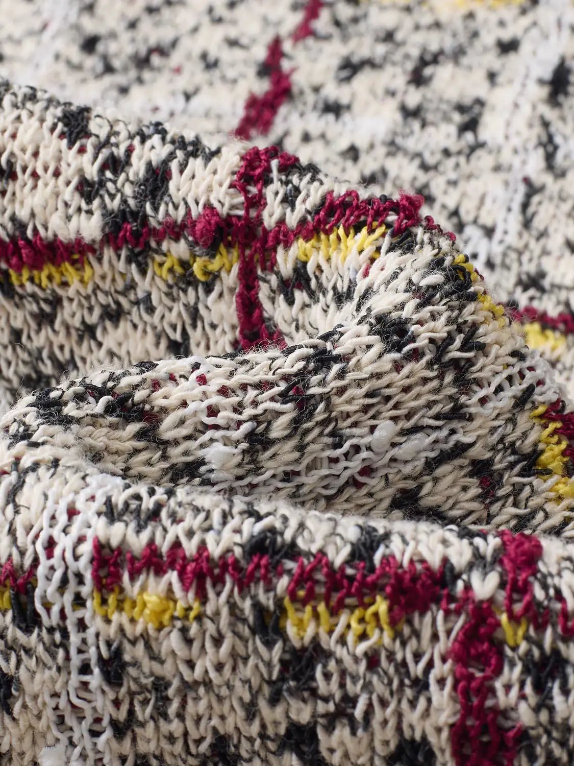 Checked fringe-hem crew-neck sleeveless knit top in cream, black and red with yellow accents