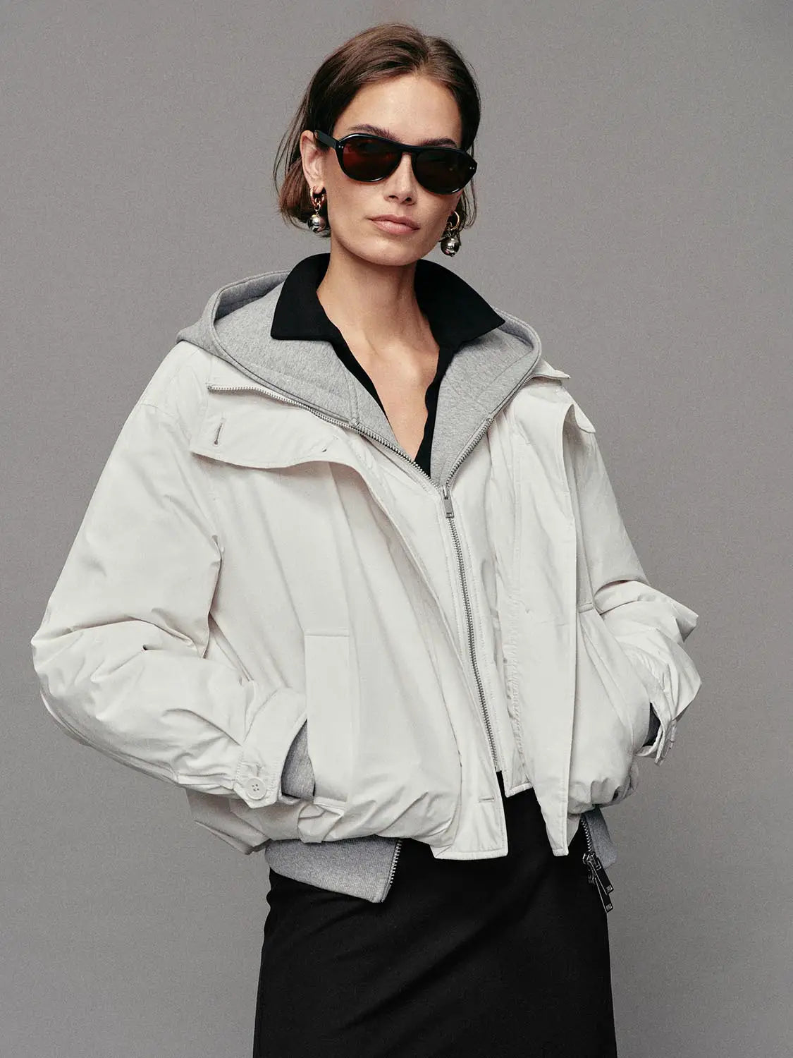 Down jacket, white oversized hooded puffer with grey lining and front zip.