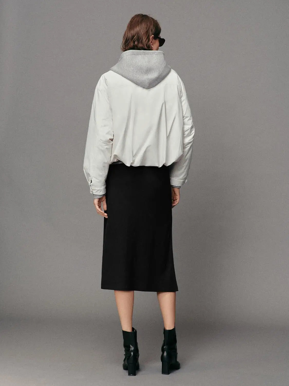 Down jacket with grey hood and cream body, back view on model