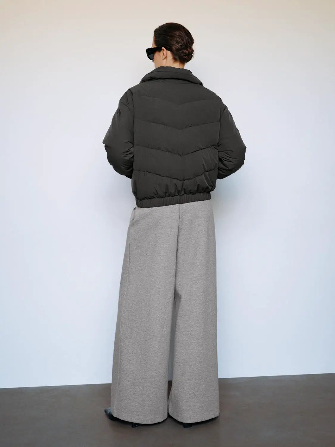 Down jacket, charcoal gray, puffer style, back view.