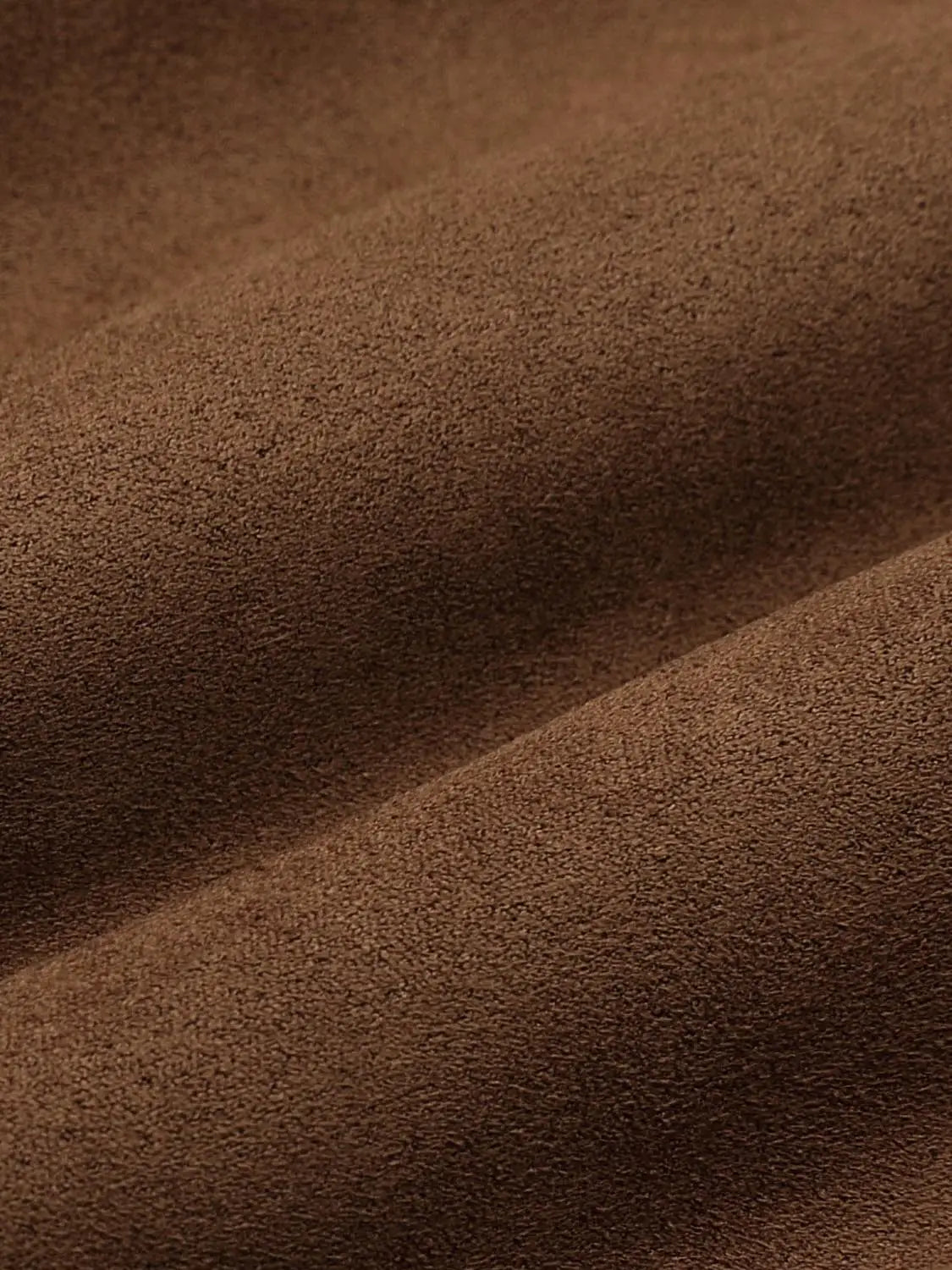 Padded jacket in brown suede-textured fabric, close-up texture detail