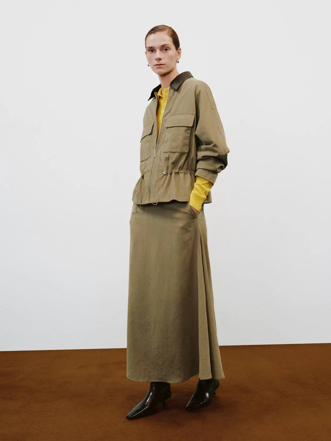 Padded Jacket in olive with black collar, front zip, drawstring waist and large front pockets