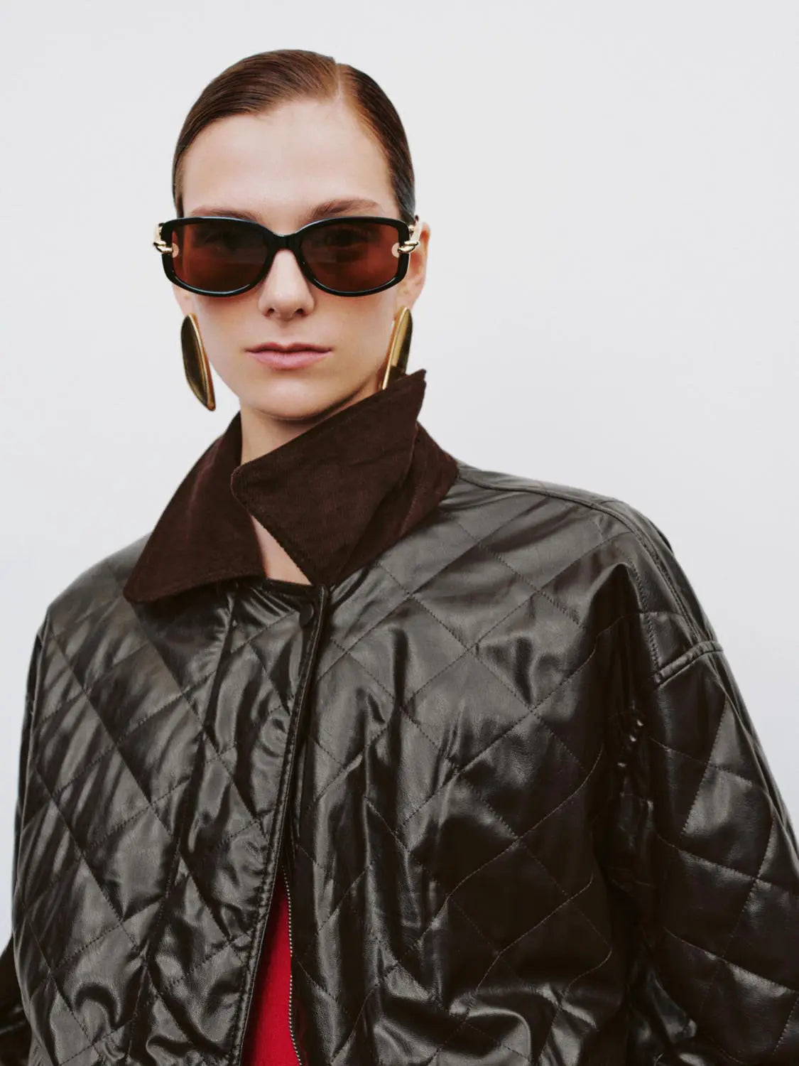 Padded jacket, black quilted finish with brown collar detail.