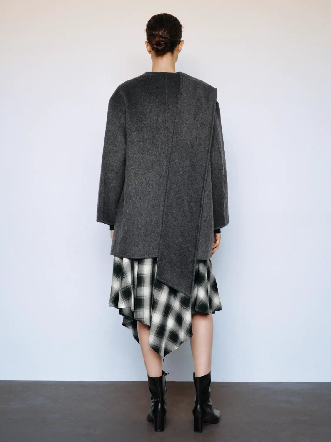 Coat by Urban Revivo Fashion, dark gray wool blend with asymmetric hem, worn over a black-and-white plaid skirt