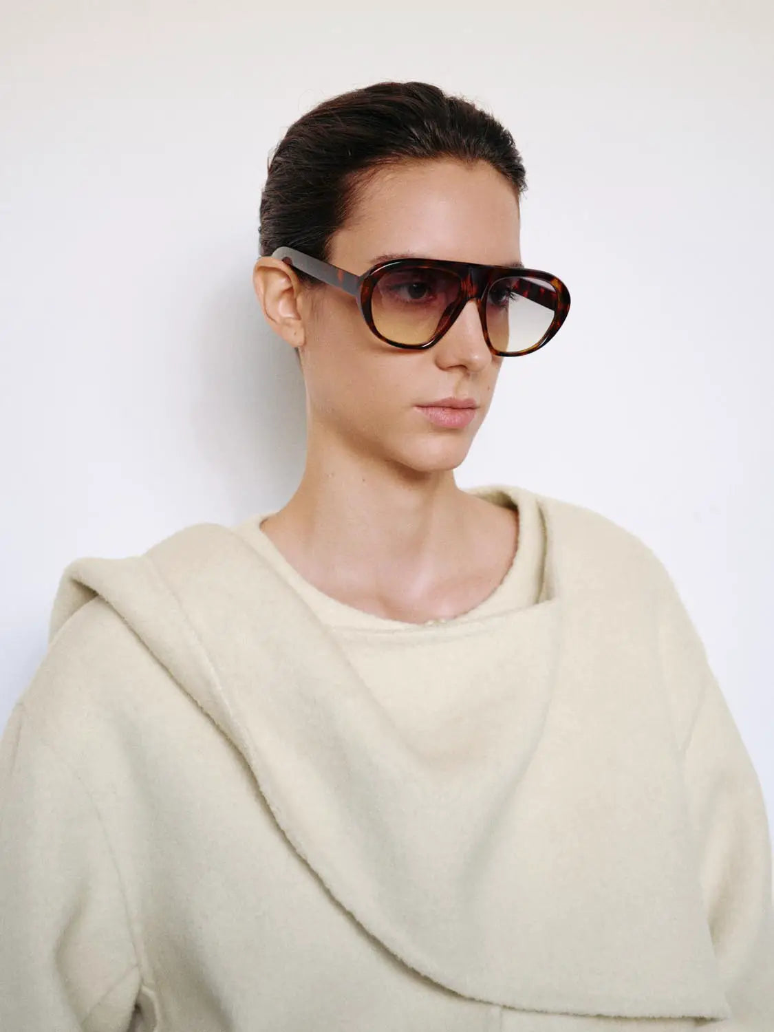 Coat in cream with oversized shawl-collar worn by model