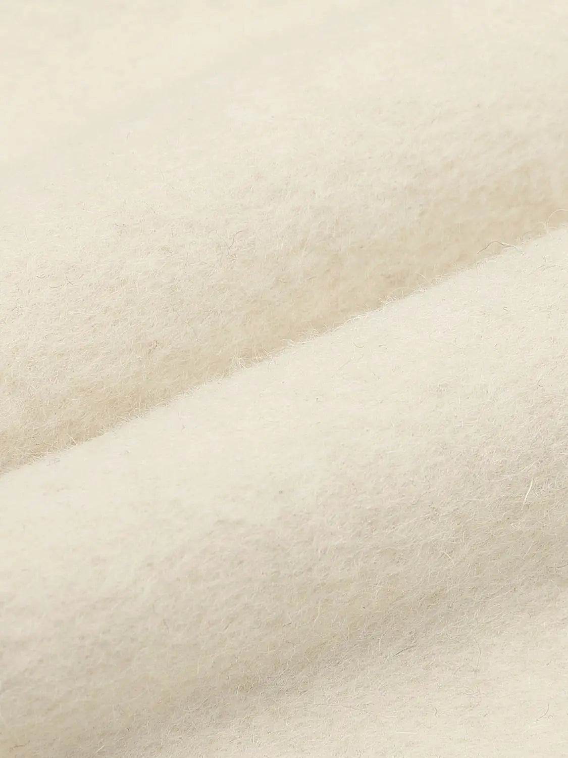 Coat fabric in creamy wool-blend texture; soft cream beige.